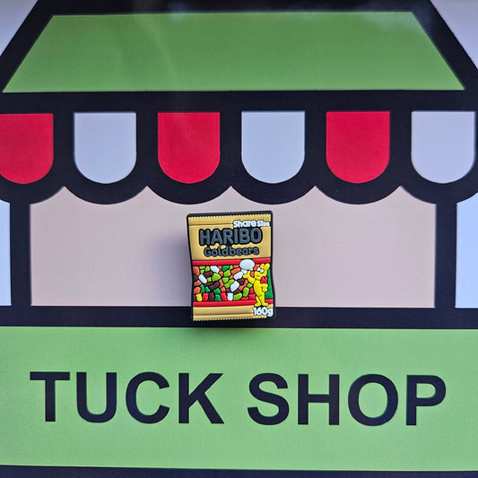 Haribo croc charm on a 'Tuck Shop' sign with colourful canopy